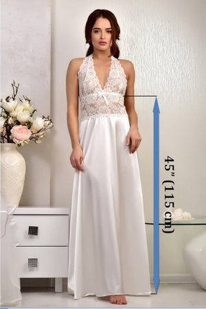 Woman wearing a white dress with lace detailing, standing indoors with a measurement label on the right