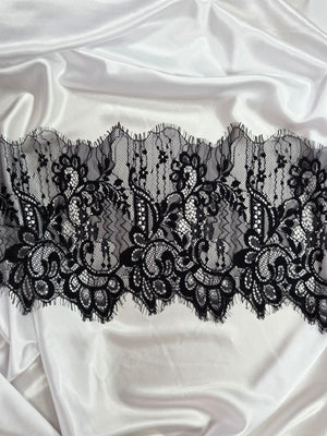 Black lace trim on satin fabric
