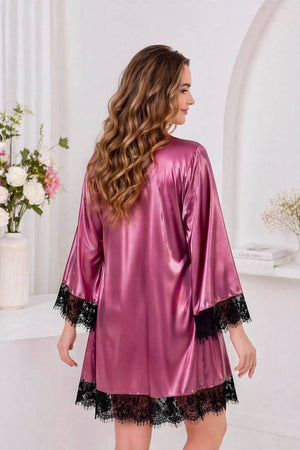 Woman pink satin robe with black lace trim