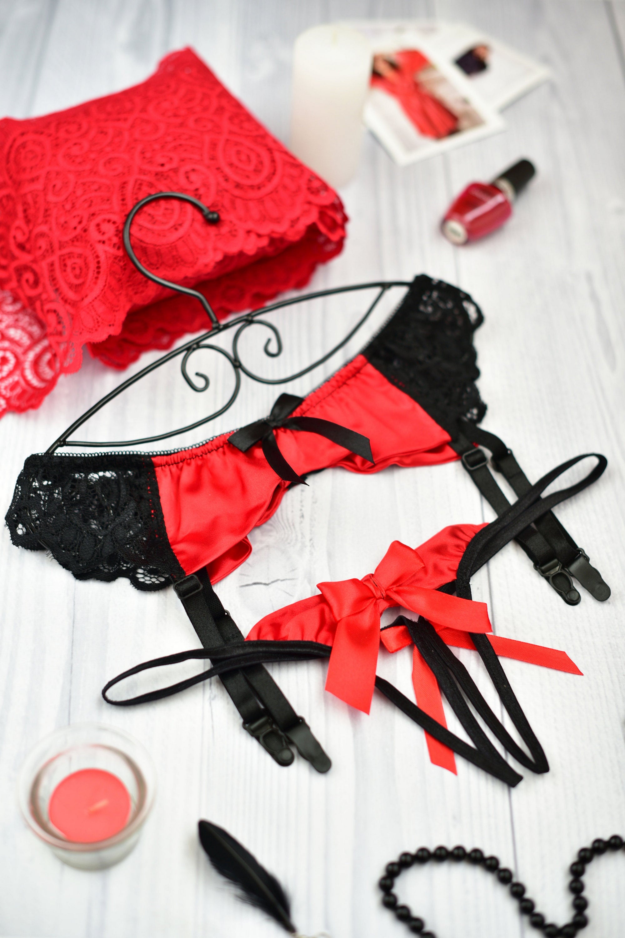 Red and black lace lingerie set with garter straps and large satin bows