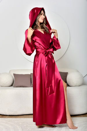Woman wearing a red satin robe in a modern living room.