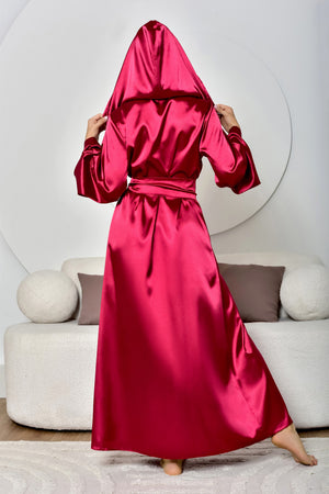 Person wearing a red satin robe in a living room setting
