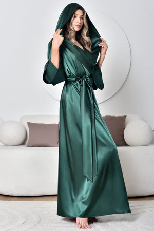 Woman wearing a green satin robe in a modern living room.