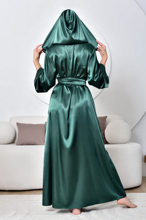 Person wearing a green satin robe in a living room setting
