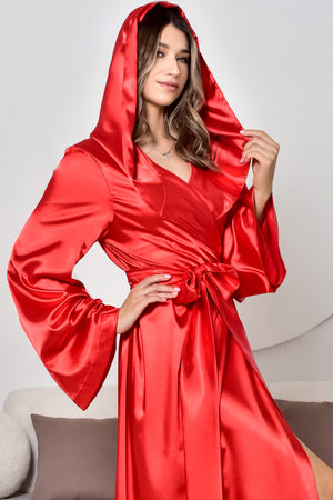 Woman wearing a red satin robe against a neutral background