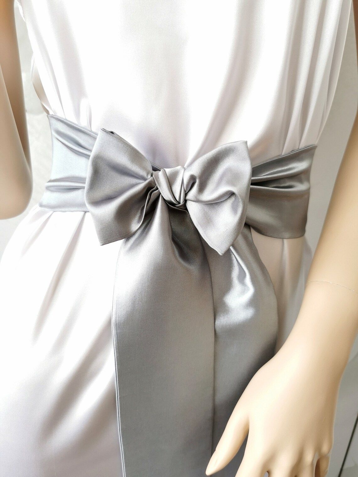 Gray satin bow belt with smooth shine and flowing ribbons