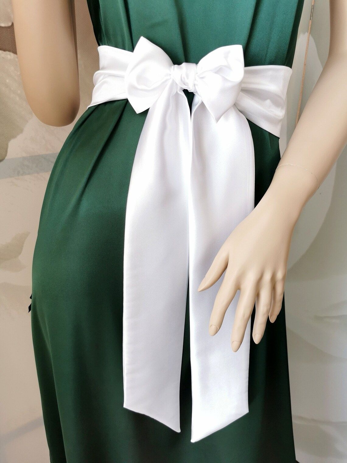 White satin sash belt tied in a long elegant bow around the waist