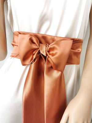 Rust terracotta satin bow belt with elegant drape