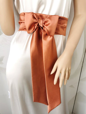 Warm terracotta satin waist belt with soft-shine bow