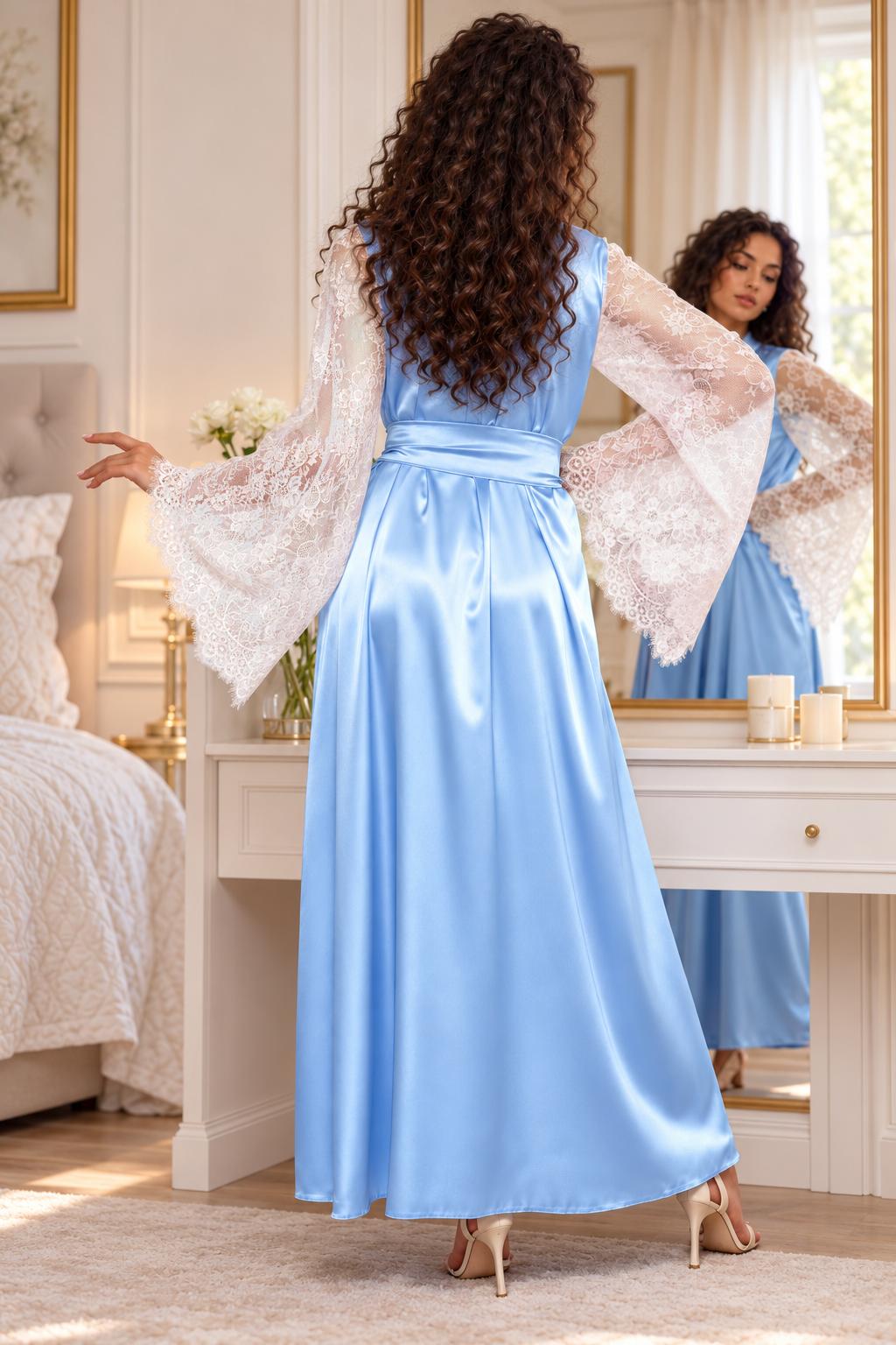 A woman stands with her back to the camera wearing a light blue satin maxi dress with sheer white lace bell sleeves