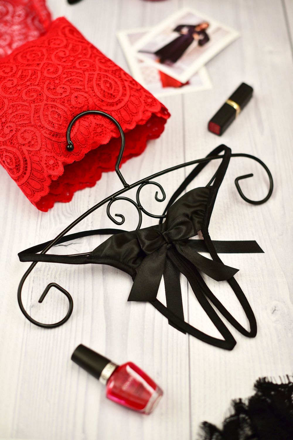 A sheer black open crotch string with satin bows