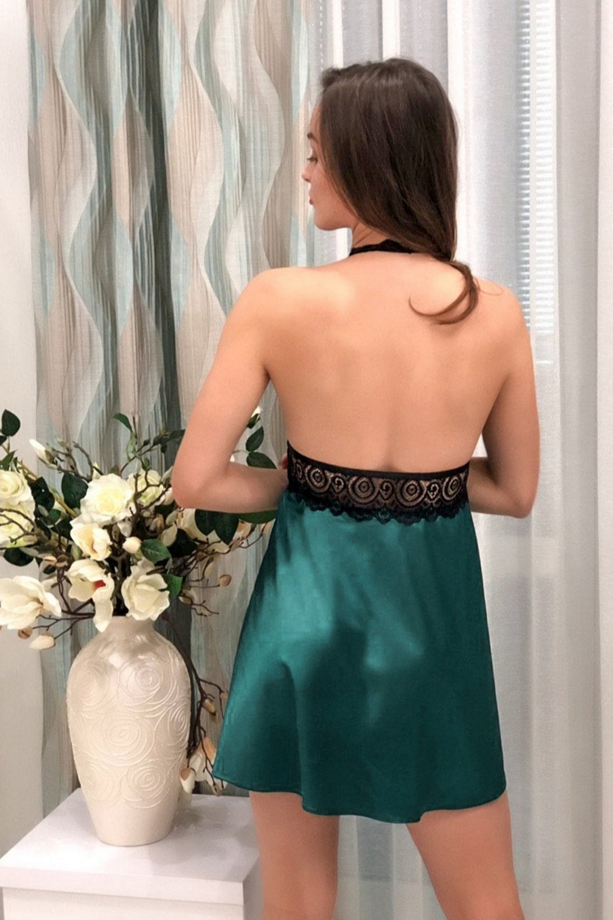 Seductive open-back detail of the dark green satin babydoll