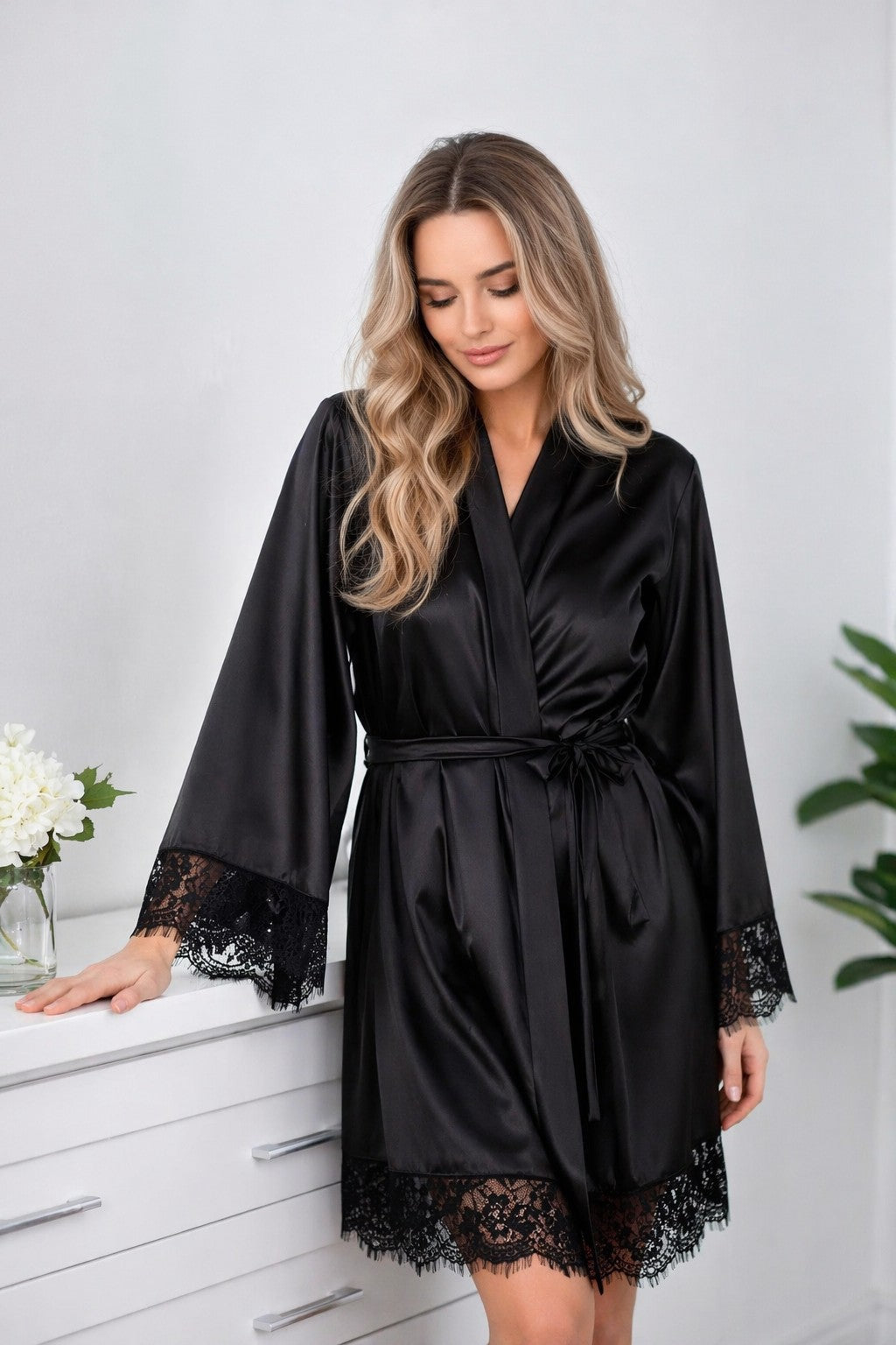 Woman's black satin robe with lace cuffs and hem