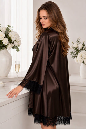 Woman wearing a brown satin robe with lace trim in a elegant room setting.