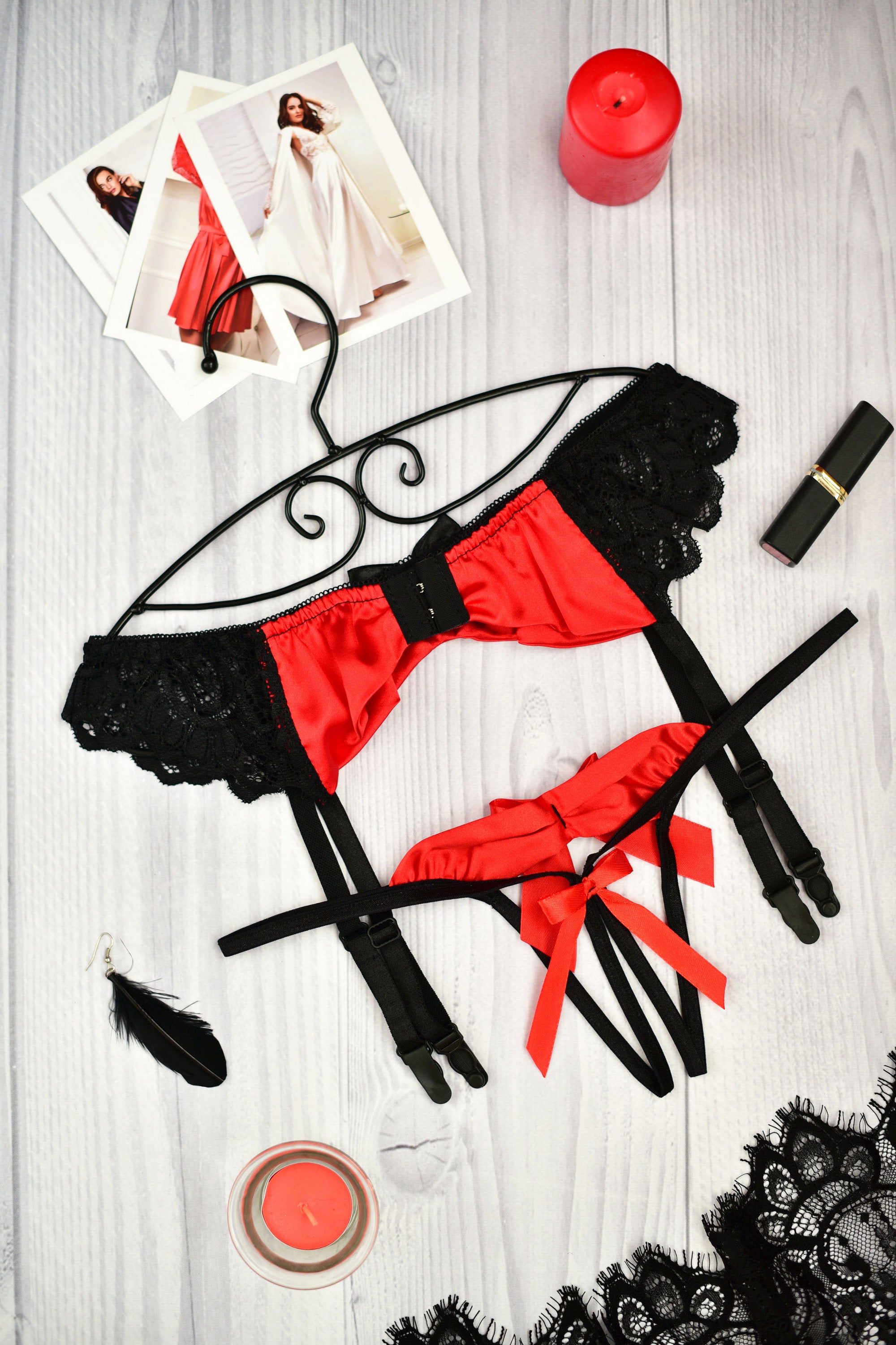 Red and black lace lingerie set with garter straps and bow details