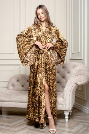 A woman in a luxurious leopard print kimono-style robe with a wide sash