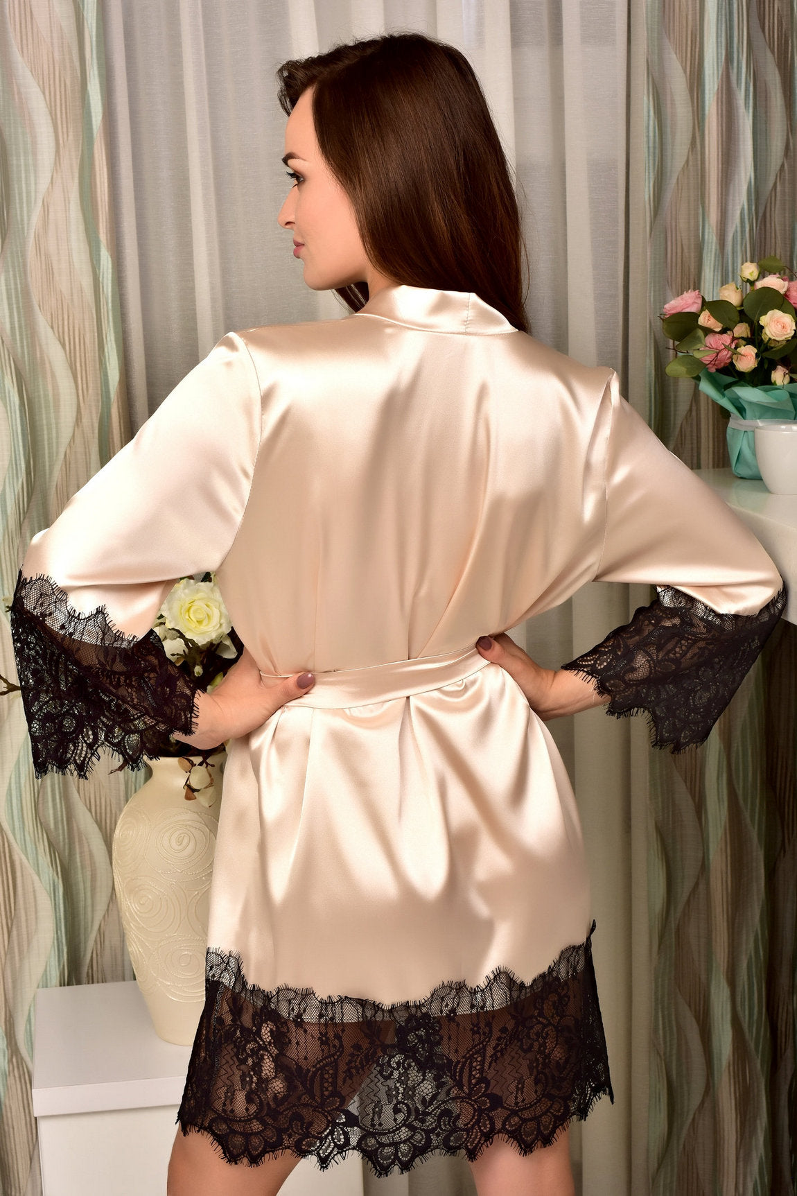 Chantilly lace trims on the sleeves and hem of the beige satin robe