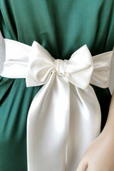 Green dress with a large ivory bow on a mannequin