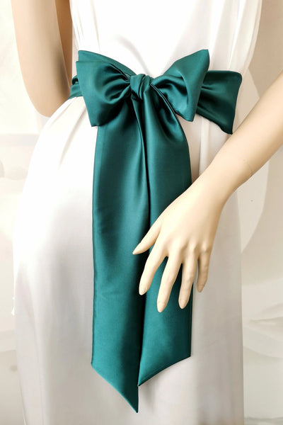 Dark green satin sash belt tied in a long elegant bow