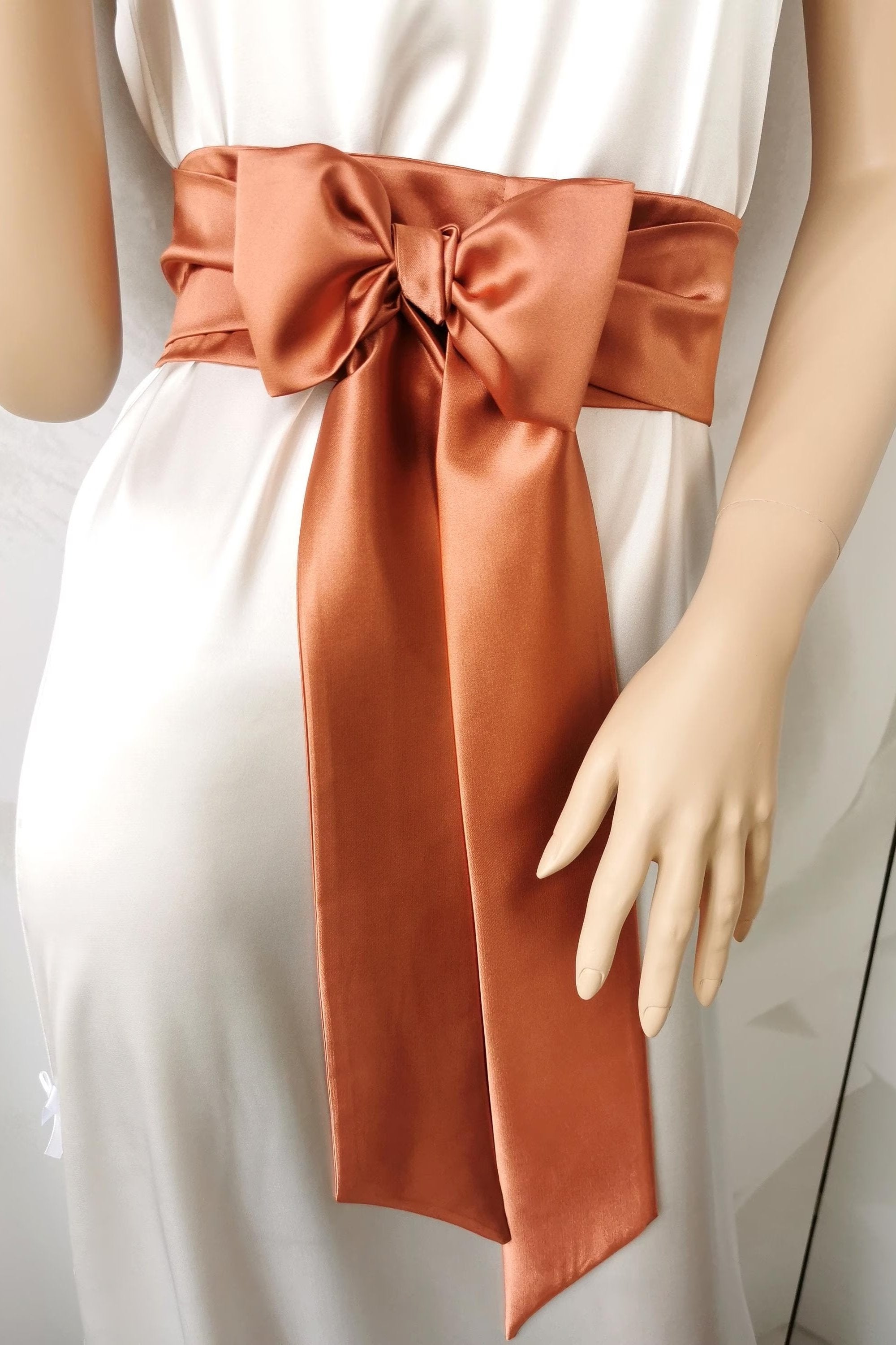 Warm terracotta satin waist belt with soft-shine bow