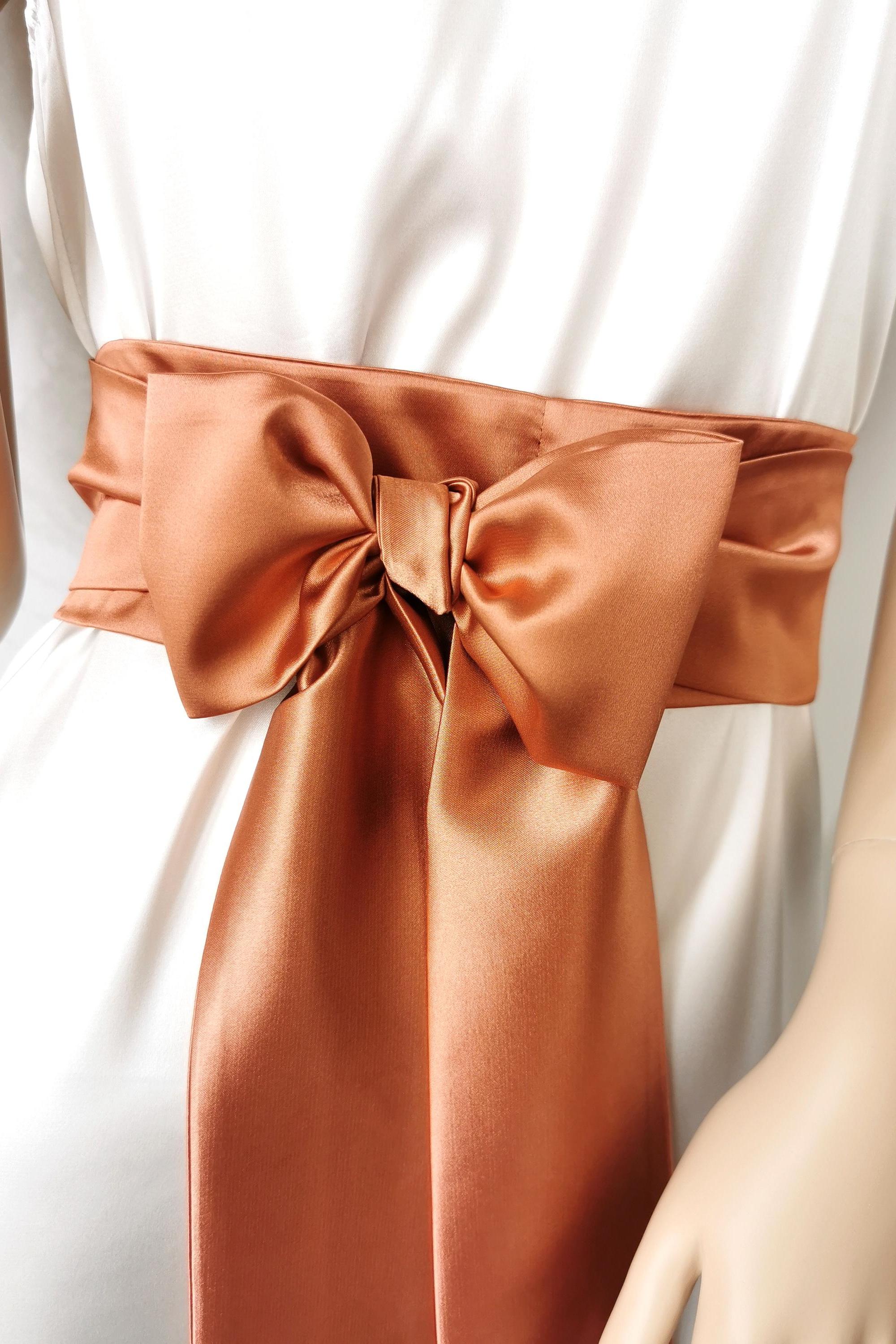 Rust terracotta satin bow belt with elegant drape