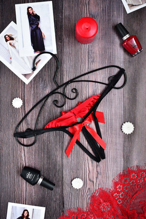 Black and red strappy lingerie thong with a red bow